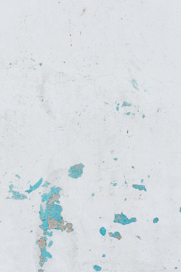 The Art of Drawing Readers In: Your attractive post title goes here A minimalist abstract texture of blue stains on a white wall, ideal for creative backgrounds.